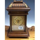 A WALNUT CASED MANTEL CLOCK, THE STRIKE MECHANISM PLAYING INTERCHANGEABLE SYMPHONION DISCS WITHIN