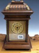 A WALNUT CASED MANTEL CLOCK, THE STRIKE MECHANISM PLAYING INTERCHANGEABLE SYMPHONION DISCS WITHIN