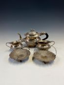 AN INDIAN WHITE METAL THREE PIECE TEA SET TOGETHER WITH A PAIR OF SWEETMEAT DISHES, THE OVERSWINGING