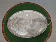 A SILVER TWO HANDLED OVAL TRAY BY HANNAM AND CROUCH, LONDON 1803, THE CENTRE ENGRAVED WITH AN