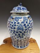 A CHINESE BLUE AND WHITE BALUSTER JAR AND COVER PAINTED WITH LOTUS SCROLLING BETWEEN TWO LAPPET
