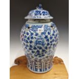 A CHINESE BLUE AND WHITE BALUSTER JAR AND COVER PAINTED WITH LOTUS SCROLLING BETWEEN TWO LAPPET