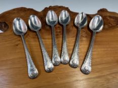 A SET OF SIX SILVER FEATHER EDGED DESSERT SPOONS, LONDON 1750, THE SHELL TOPPED HANDLES WITH A CREST