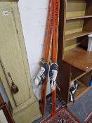 TWO PAIRS OF SKIS, SKI STICKS, A PAIR OF BOOTS AND A PAIR OF SKATING BOOTS