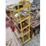 A YELLOW PAINTED IRON FIVE SHELF SHOP DISPLAY TROLLEY