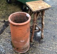 A CHIMNEY POT AND A RUSTIC PLANT STAND.