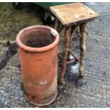 A CHIMNEY POT AND A RUSTIC PLANT STAND.