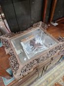 A RECTANGULAR MIRROR WITHIN A CHINESE PIERCED AND CARVED WOOD FRAME