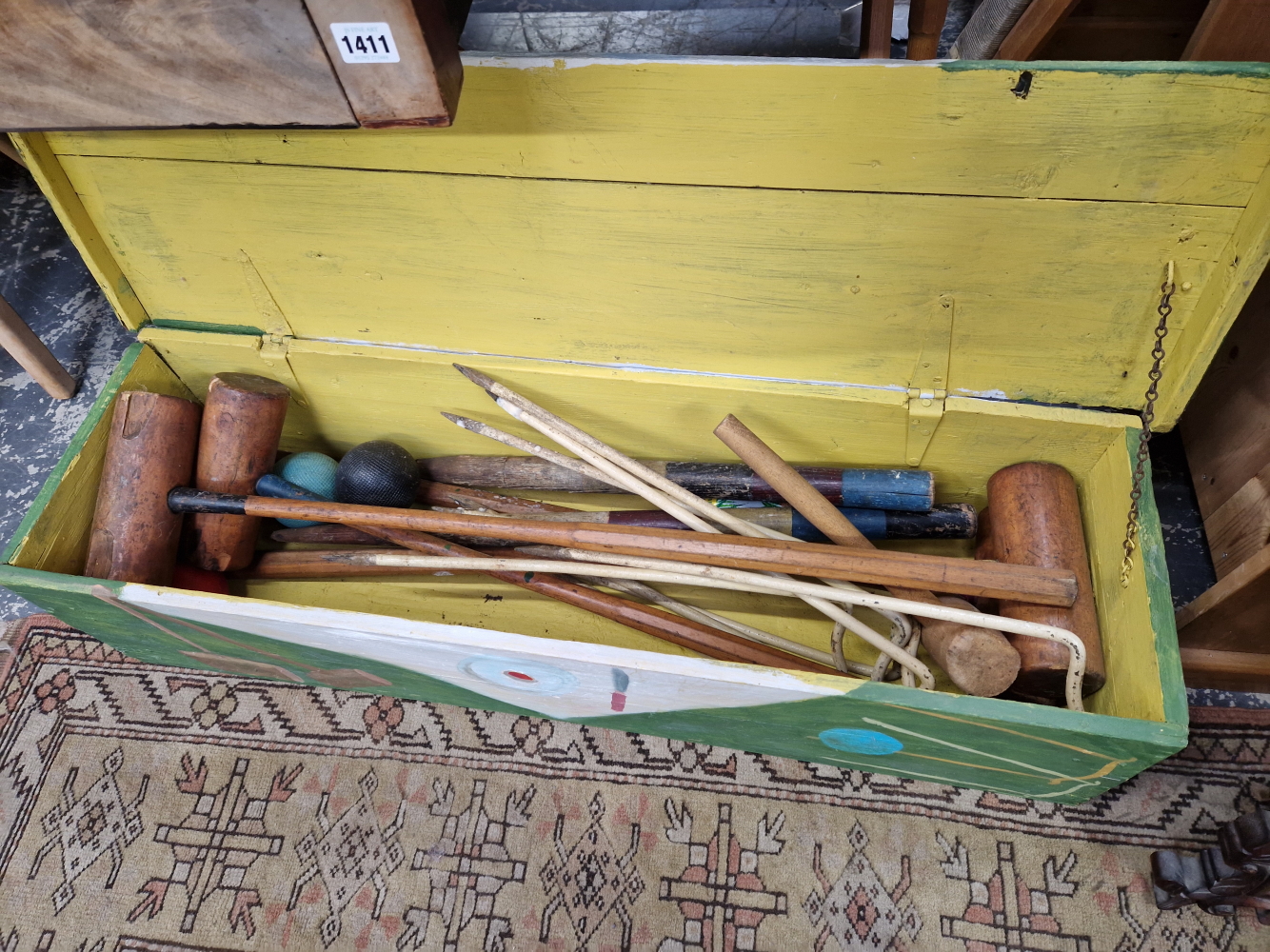 A CROQUET SET IN A PAINTED WOODEN BOX TOGETHER WITH OTHER MALLETS AND A HOCKEY STICK