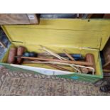 A CROQUET SET IN A PAINTED WOODEN BOX TOGETHER WITH OTHER MALLETS AND A HOCKEY STICK