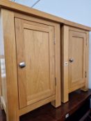 A PAIR OF OAK BEDSIDE CABINETS.