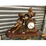 A 19th C. FRENCH SPELTER AND RED MARBLE CLOCK FLANKED BY A NYMPH RAISING HANDS UP TO A WATER