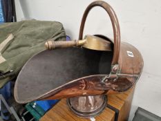 A COPPER COAL SCUTTLE FITTED WITH A BRASS SHOVEL