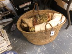 A BASKET OF WOVEN AND OTHER TEXTILES