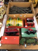 A HORNBY 0 GUAGE CLOCK WORK LOCOMOTIVE, TENDER, ROLLING STOCK, RAIL AND A LEVEL CROSSING