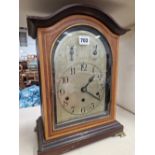 A GERMAN SATIN WOOD BANDED MAHOGANY MANTEL CLOCK, THE MOVEMENT CHIMING ON RODS, THE SILVERED DIAL