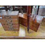 A BRAS HANDLED MAHOGANY BOX TOGETHER WITH A FIVE DRAWER CABINET OF CLOCK MAKERS TOOLS AND PARTS