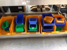 A COLLECTION OF PLASTIC STORAGE TRAYS IN VARIOUS SIZES