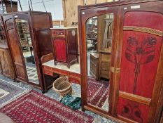 AN ART NOUVEAU BEDROOM SUITE, COMPRISING OF TWO WARDROBES, DRESSING TABLE AND BEDSIDE CABINET.