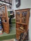 A PAIR OF ERCOL CORNER CABINETS.