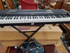 A CASIO CPS-700 ELECTRIC ORGAN ON FOLDING STAND
