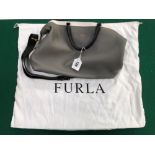 AN UNUSED FURLA HANDBAG.