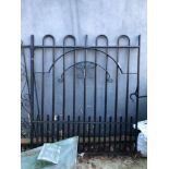 A LARGE BLACK PAINTED IRON GATE.