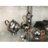 A NICK MUNRO STAINLESS STEEL FOUR PIECE TEA SET, SALT AND PEPPER