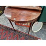 A 20th C. LINE INLAID MAHOGANY DEMILUNE TABLE TOGETHER WITH A ROUND MIRROR IN A WHITE PLASTIC