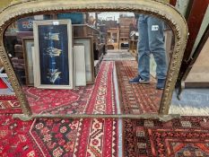 A VICTORIAN GILT FRAMED OVER MANTLE MIRROR.