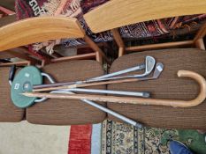 TWO IRON GOLF CLUBS, A WALKING STICK WITH AUSTRIAN TOWN BADGES AND A NATIONAL TRUST SHOOTING STICK