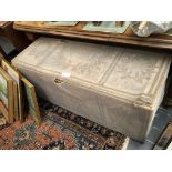 A PINE BLANKET BOX WITH MUSICAL INSTRUMENT DECORATION NEEDLEWORK PANEL COVERS.