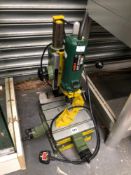 A BOSCH POF 600 ACE DRILL ON ADJUSTABLE STAND
