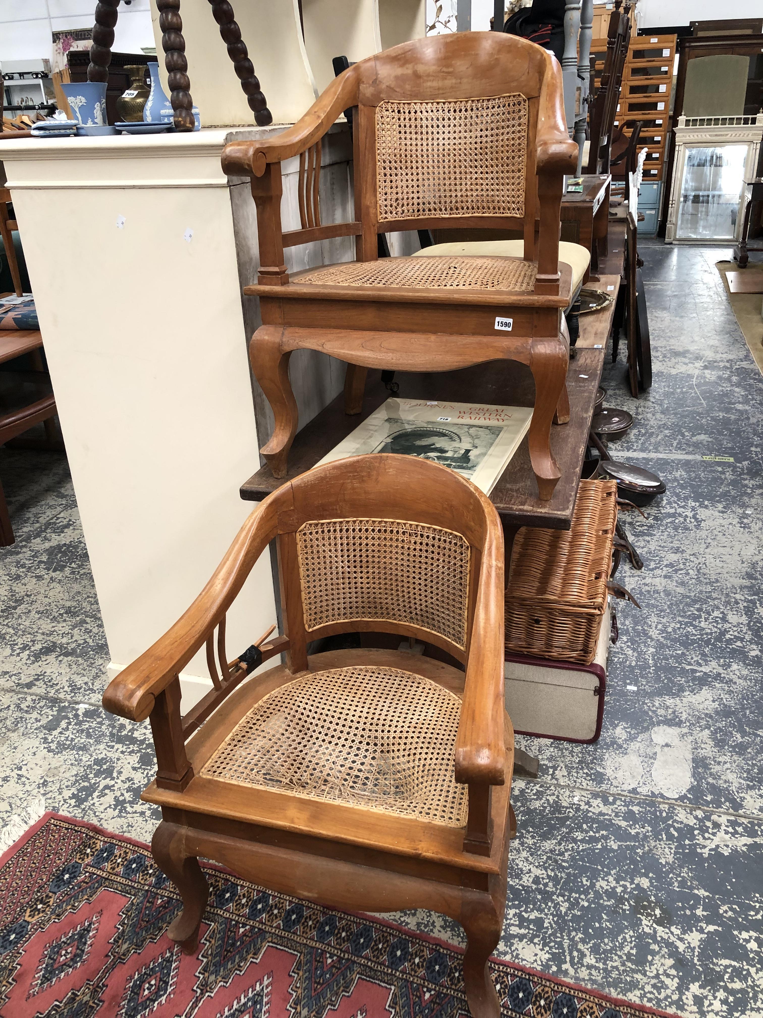 A PAIR OF HARDWOOD ARMCHAIRS.