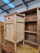 A PINE BEDSIDE CABINET AND A SMALL BOOKCASE.