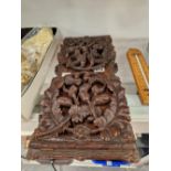 A MAHOGANY BOOK SLIDE, THE ENDS PIERCED AND CARVED WITH BUDS AMONGST FOLIAGE