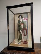 A JAPANESE DOLL IN A GLAZED CASE