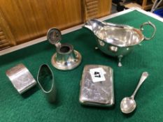 A HALLMARKED SILVER CIGARETTE BOX, TWO NAPKIN RINGS, A SAUCE BOAT, SMALL INKWELL AND A SPOON.