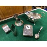 A HALLMARKED SILVER CIGARETTE BOX, TWO NAPKIN RINGS, A SAUCE BOAT, SMALL INKWELL AND A SPOON.