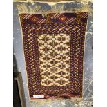 AN ORIENTAL RUG OF BOKHARA DESIGN 120 x 80cms