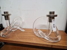 A PAIR OF CANDLESTICK WITH CHROMED NOZZLES SUPPORTED ON KNOTTED CYLINDRICAL CLEAR PLASTIC BASES