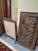 AN ORIENTAL CARVED HARDWOOD PANEL AND AN OAK FIRE SCREEN.