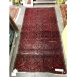 AN AFGHAN RUG. 240 x 124cms TOGETHER WITH A SMALL BELOUCH PRAYER RUG (2)