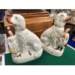 A RARE PAIR OF STAFFORDSHIRE SPANIELS WITH FIGURES.