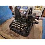 A COLLECTION OF SIX TYPEWRITERS, AN ADDING MACHINE AND ANOTHER MACHINE WITH TELEPHONE HAND SET