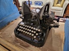 A COLLECTION OF SIX TYPEWRITERS, AN ADDING MACHINE AND ANOTHER MACHINE WITH TELEPHONE HAND SET