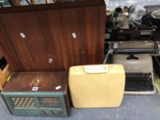 A CUPBOARD ENCASED DART BOARD, TWO TYPEWRITERS AND AN HMV RADIO