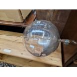 A CLEAR PLASTIC TERRESTIAL GLOBE ROTATING ON AN IRON ROD