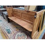 AN ANTIQUE PINE PEW. 90 X 167 X 50CMS.