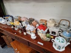 A COLLECTION OF NOVELTY TEA POTS OF HOUSE AND OTHER FORMS